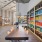 a long wood table with seating and a bookshelf