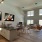 Open concept apartment home with high ceilings, large windows with ample lighting, and stairs leading to a loft at Arts District
