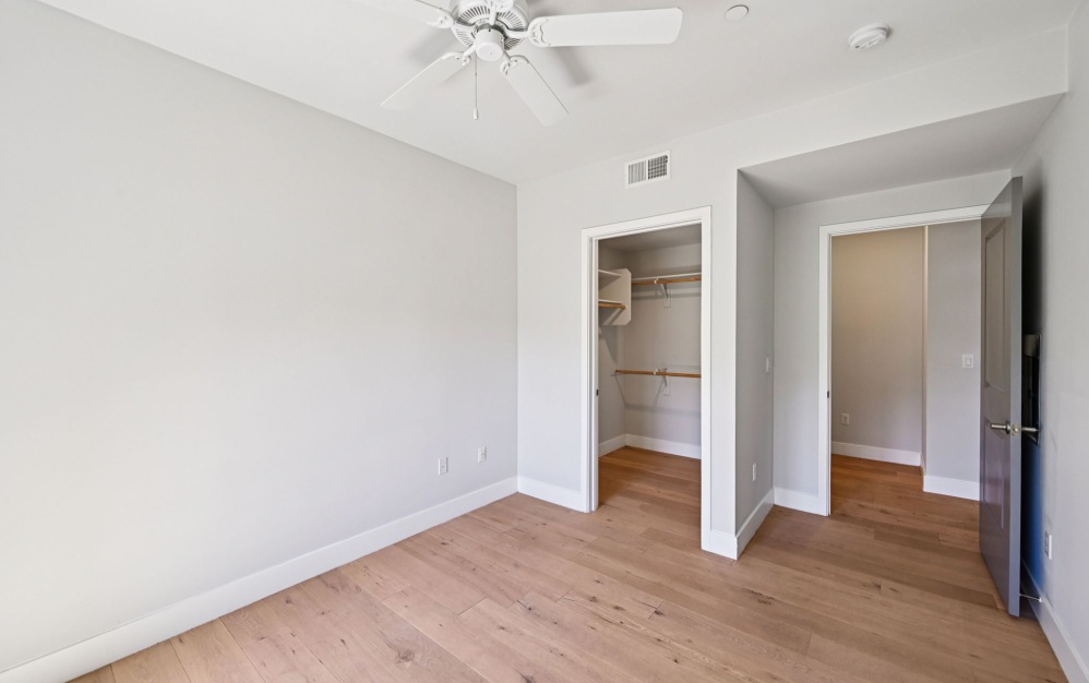 Unfurnished apartment bedroom with wood-like plank flooring at Arts District
