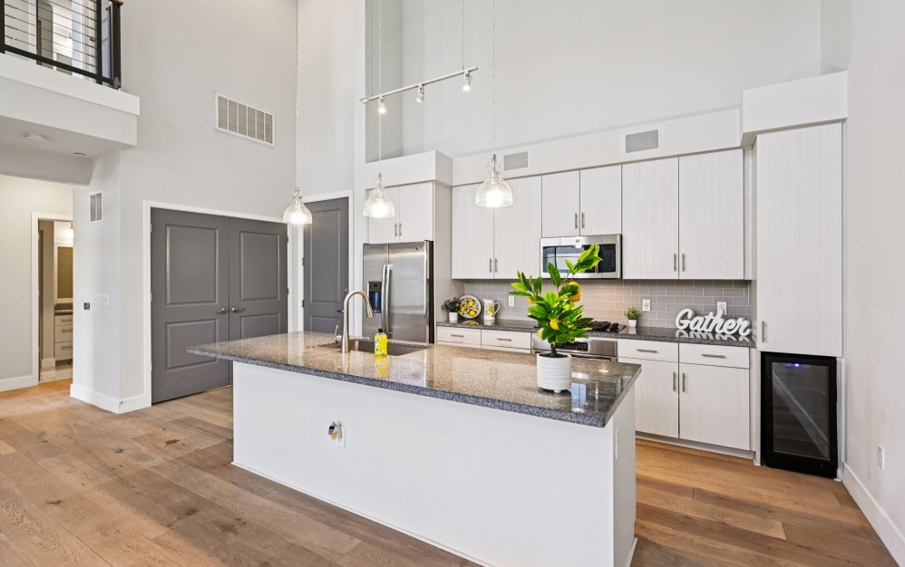 Modern apartment kitchens with ample counterspace and stainless steel appliances at Arts District 