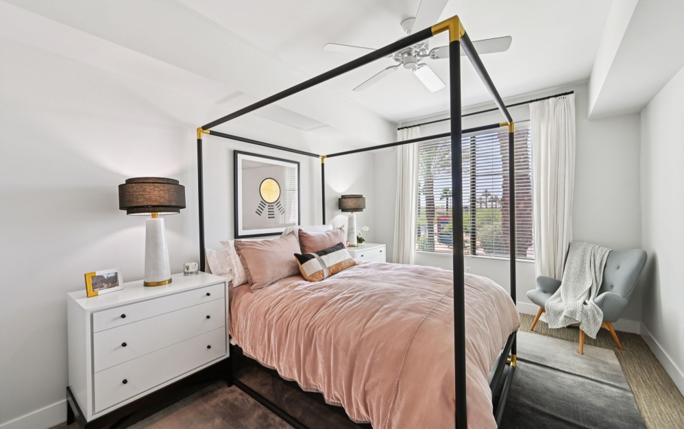Furnished apartment bedroom with a large window at Arts District 