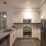 Arts District apartment home kitchen with stainless steel appliances and modern white cabinetry
