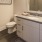 Arts District apartment bathroom with wood flooring and ample vanity storage