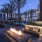 Community firepit with ample seating and tropical landscaping at Arts District