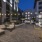 Outdoor courtyard area with ample seating, water features , and string lighting at Arts District
