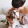 woman sitting on a beige couch with her dog in her lap